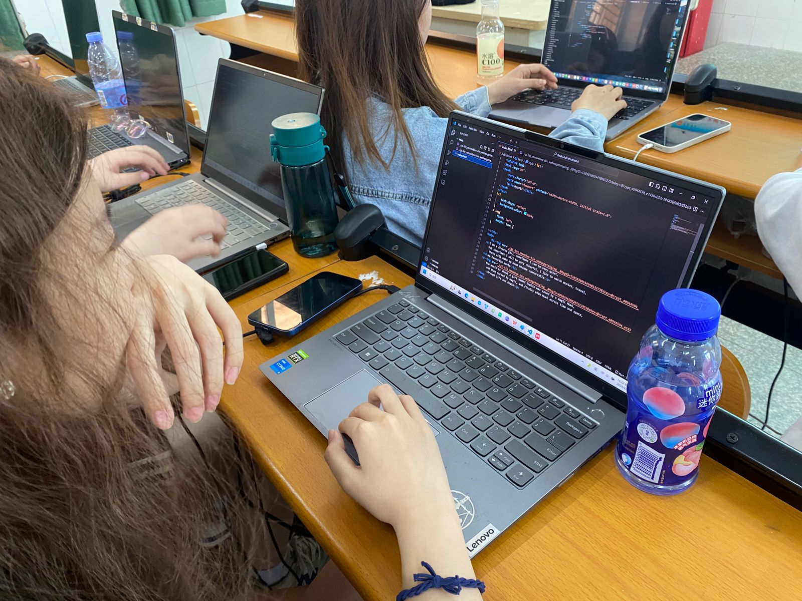 Female student working on web development HTML CSS JavaScript exercise at Yango University